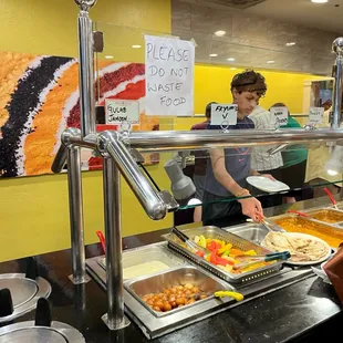 a woman serving food at a buffet