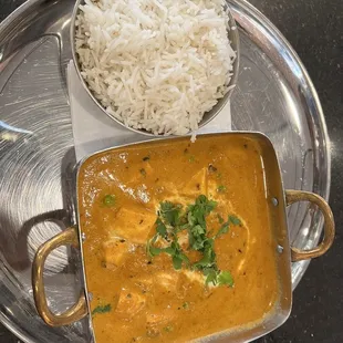 a plate of rice and a curry dish