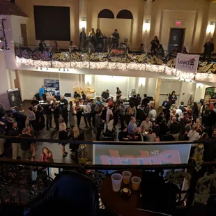 a crowd of people standing in a hall