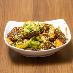 a bowl of food on a wooden table