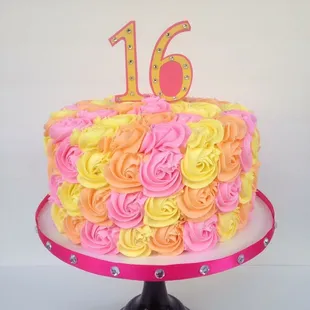 a pink and yellow rose cake