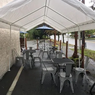 tables and chairs under a tent