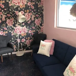 a living room with floral wallpaper