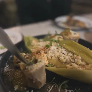 BONE MARROW ESQUITE Street Style Corn. Arbol Aioli. Dried Hot Sauce. Swect Com Tamale. Salsa Verde