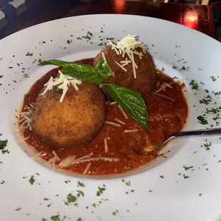 Arancini- deep fried saffron risotto balls stuffed with bolognese topped with Parmesan and basil.