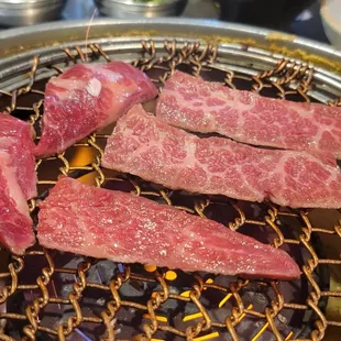 steaks being cooked on a grill