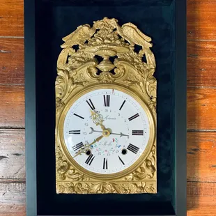 Antique clock framed in black velvet shadow box