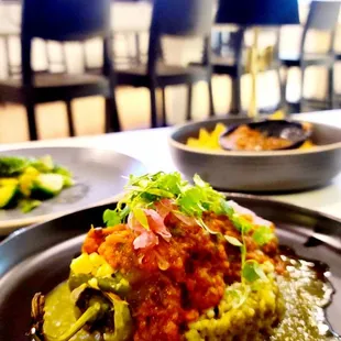 Vegan Chile Relleno - pepper stuffed with fresh corn and sauteed veggies, with a delicious mix of red and green salsas.