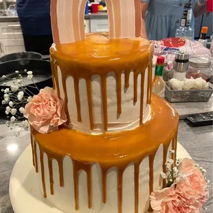 a three layer cake with caramel drips