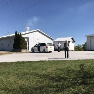 two people standing in front of a house