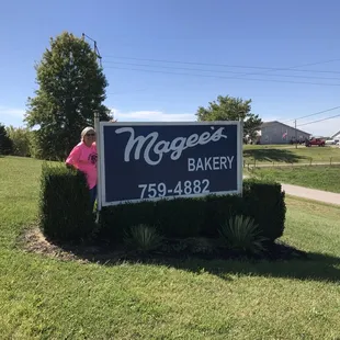 a woman standing in front of a sign
