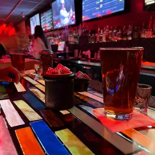 a beer and a bowl of fruit