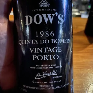 a hand holding a bottle of wine