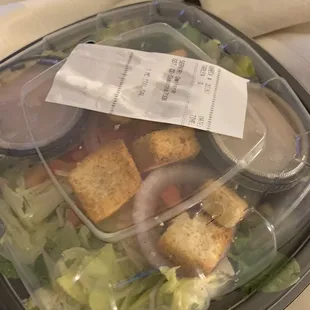 a salad in a plastic container