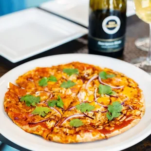 a pizza and a glass of wine