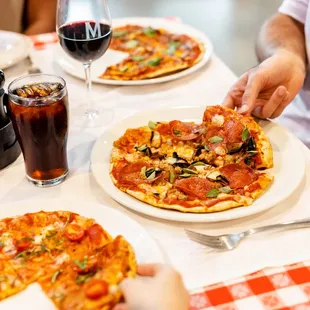 a person taking a slice of pizza