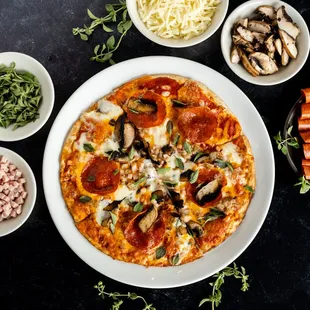 a pizza with pepperoni, mushrooms, and cheese