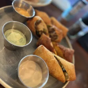 a plate of sandwiches and dippings