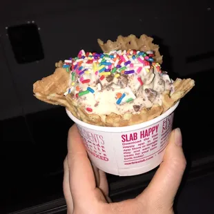 Coffee ice cream with crunch bar and sprinkles on top... In a waffle bowl