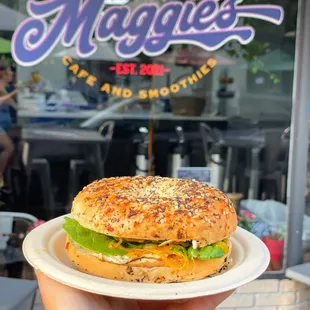 a hand holding a sandwich