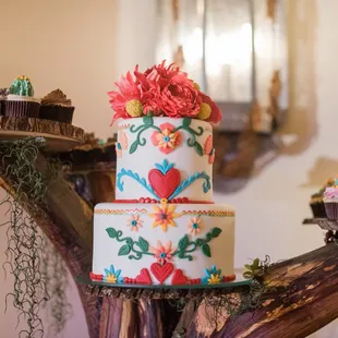 a three tiered cake with flowers on top