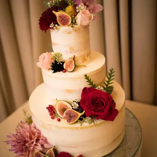 a wedding cake with figs and flowers