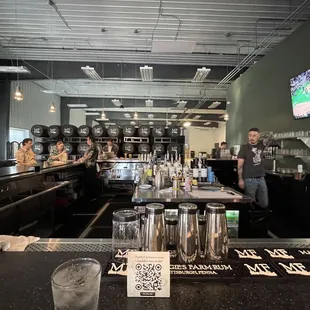 a bar with people sitting at the bar