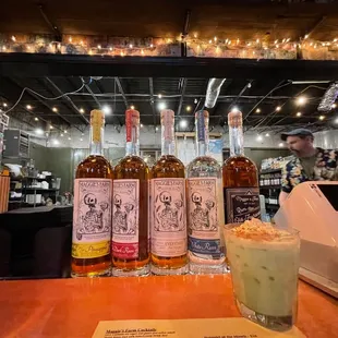 three bottles of rum and a drink