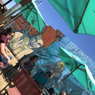people sitting under umbrellas