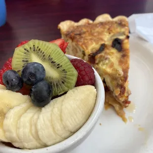 a slice of pie and a bowl of fruit