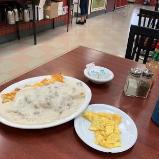 Biscuits and gravy with hashbrowns and side of an egg