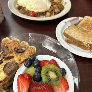 Quiche with fruit cup Corn beef hash and egg