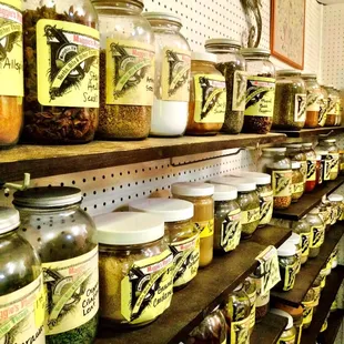 a shelf full of jars of spices