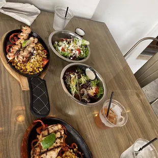 Tequila lime chicken and shrimp skewer with side salad and street corn.