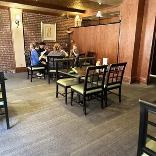people sitting at tables in a restaurant