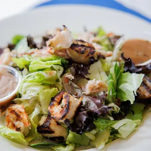 a salad with shrimp and lettuce