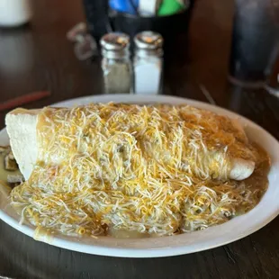 Gargantuan breakfast burrito. Salt and pepper shakers for comparison