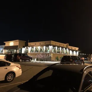 cars parked in a parking lot at night