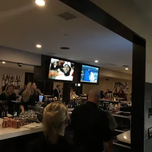 a group of people sitting at a bar