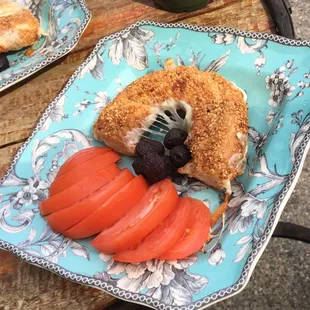 simit with cheese, served with tomatoes and olives.