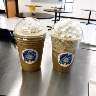 two cups of coffee with whipped cream on top