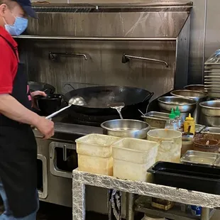 Owner making my Hot &amp; Sour Soup while I wait!