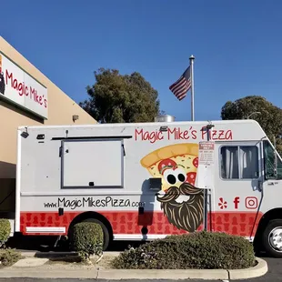 a food truck parked in front of a restaurant