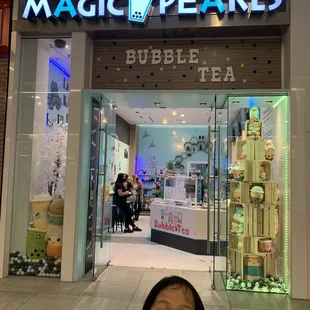 a little girl in front of a store