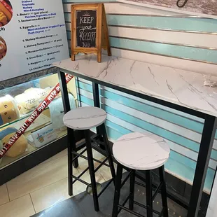 a counter with two stools