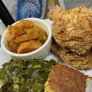 a plate of fried chicken, cornbreads, and greens