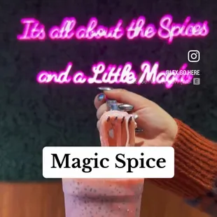 a person holding a glass of juice