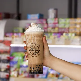 a hand holding a cup of iced coffee