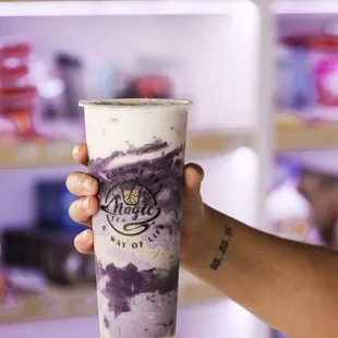 a hand holding a cup of ice cream