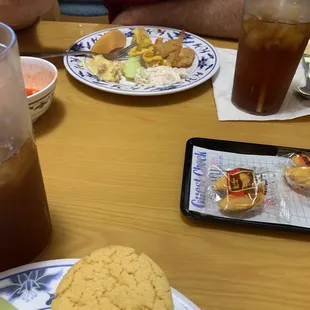 a man sitting at a table with food and drinks